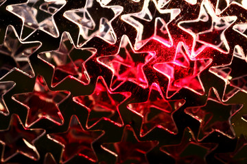 Gold coloured star shaped background with red laser illuminating the centre of the image