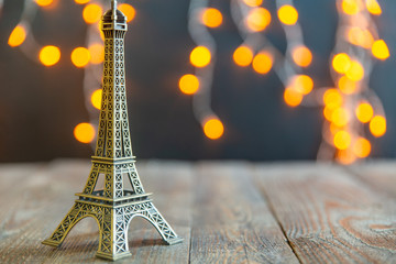 figurine of the Eiffel tower on a background garlands