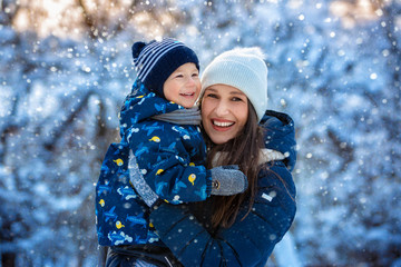 Woman and child in winter in nature. Portrait of a happy family