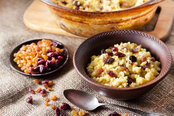 Sweet millet porridge with raisins and dried cranberries