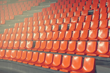 Orange seats in the stands of sports stadium