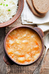Kapustnyak - traditional ukrainian winter soup with sauerkraut, millet and meat