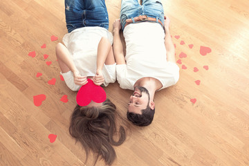 Funny valentines couple is lying on the floor. Top view.