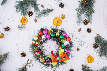 Christmas wreath with New Year's decor on a white wooden background