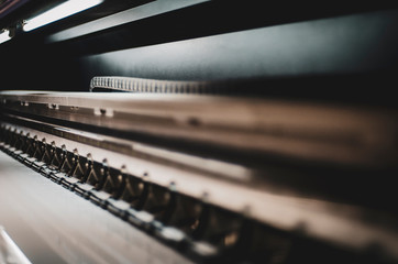 Fragment of the offset printing machine during the printing at the manufacturing with copy space