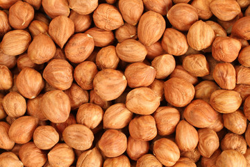 Hazelnuts background. Heap of peeled hazelnuts. View from above. Closeup