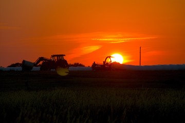 Fototapeta premium Tractor at Sunseet