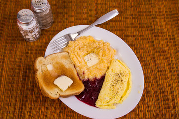 Cheese Omelet with Buttered Grits and Grape Preserves and Toast