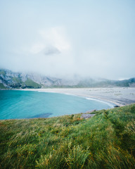 Beach by the foot of a mountain