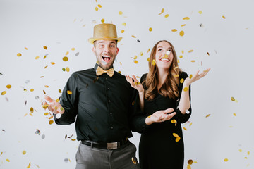 Couple throwing confetti at Party