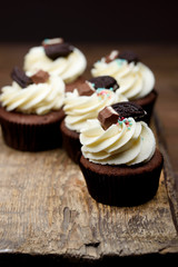 Chocolate, tasty and sweet cupcake with vanilla cream and condensed milk inside