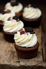Chocolate, tasty and sweet cupcake with vanilla cream and condensed milk inside