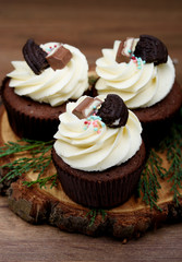 Chocolate, tasty and sweet cupcake with vanilla cream and condensed milk inside
