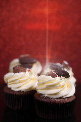 Chocolate, tasty and sweet cupcake with vanilla cream and condensed milk inside. Minimal food bakery concept.