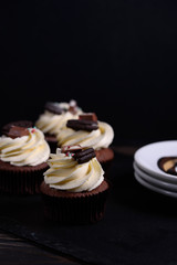Chocolate, tasty and sweet cupcake with vanilla cream and condensed milk inside. Minimal food bakery concept.