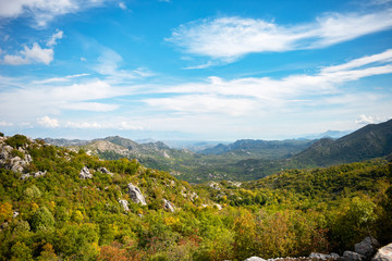 panorama of mountains with rocks and sky and clousd