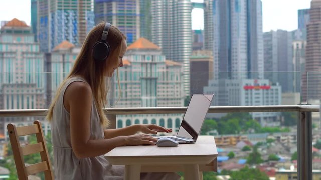 Remote techer has a conversation with a student through the internet at a balcony with a background of a city center full of skyscrapers. Student choosing e-learning program, easy effective self