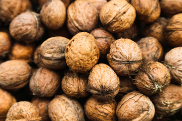Natural walnut background pattern texture Abstract walnuts heap pattern background Blurred edges frame Natural food in-shell nuts walnuts pattern backdrop