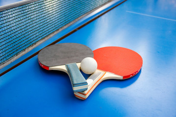 Table tennis gear. Ping pong rackets and ball  on table with net