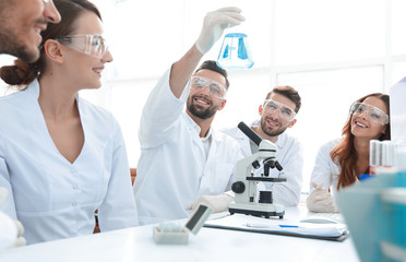 group of young workers are working in biochemistry lab,