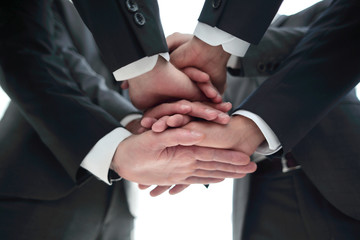 Close-up of businesspeople stacking hands in meeting