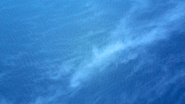 Misty cold winter sea. Blue ocean background with smooth clouds and beautiful mysterious textures. Moving abstract ocean wave pattern with many little clouds. 