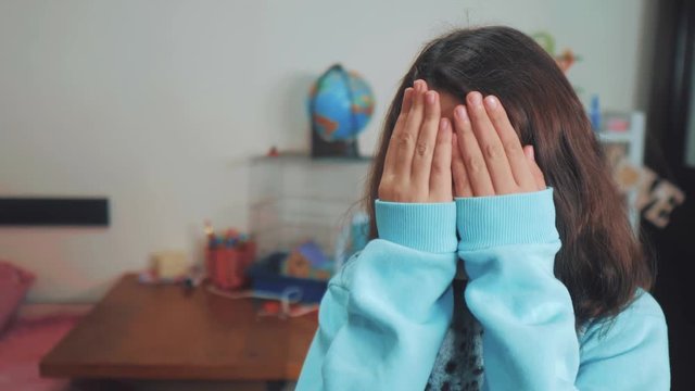 peek a boo. little girl covered her eyes face with her hands hide-and-seek waiting for a surprise. slow motion video. teen girl playing bo-peep. childhood concept game hy - spy lifestyle