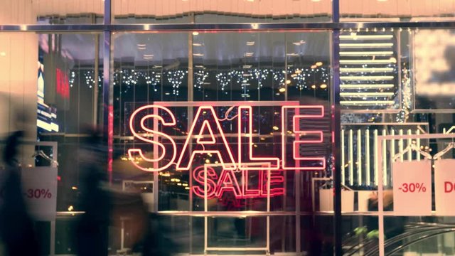 Sale sign on the street full of people. Unrecognizable people on the street. Time lapse 4k footage.