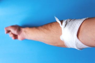 bandaged male hand after blood from a vein