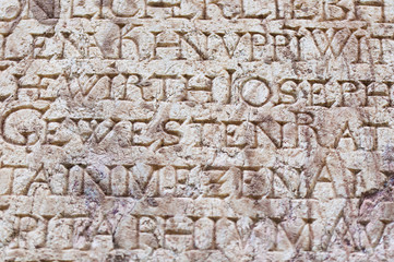 religious engraved letters on stone wall