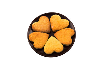 Heart shaped cookies on a round plate. Isolated on white background. Baking for Valentine's Day.