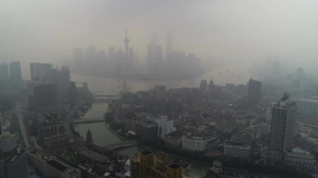Panoramic drone flight over Shanghai skyline at cloudy moody morning