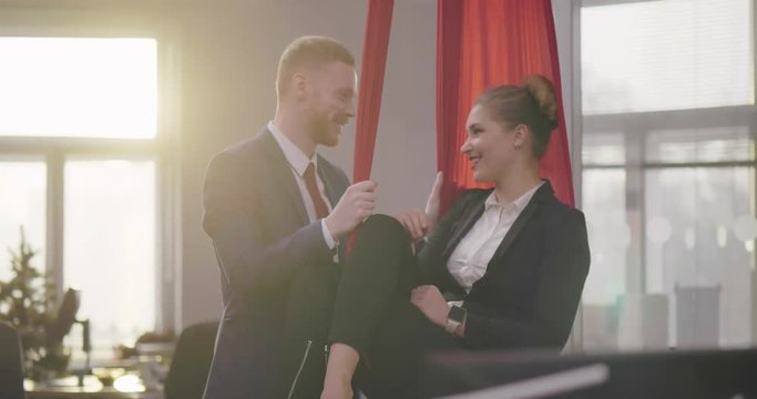 Female boss flirting with her employee. Relationships at work. .
