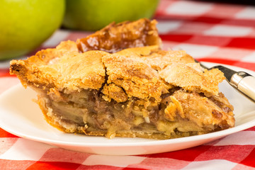 Closeup of Apple Pie in Country Kitchen Setting on Red Plaid Tablecloth