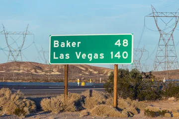 Foto op Plexiglas Late afternoon view of Las Vegas 140 miles and Baker 48 miles highway sign on I-15 near Barstow in California.   © trekandphoto