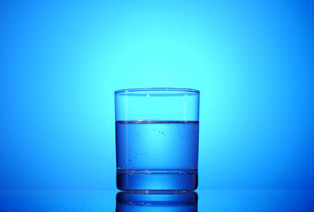 Glass with mineral water on a beautiful background.