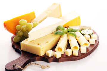 Cheese plate served with grapes, various cheese on a platter