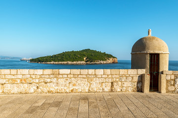 A Gun turret on old city walls of Dubrovnik with Lokrum in background © Deniz
