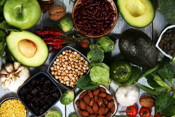 Healthy food clean eating selection. fruit, vegetable, seeds, superfood, cereals, leaf vegetable on rustic background