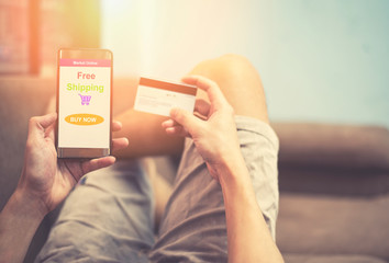 online shopping man using smartphone shopping in website market online and hands holding credit card