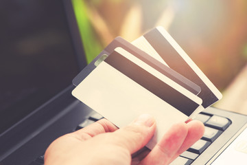 credit card and using laptop easy payment online shopping credit and debit card in hand for shopping online
