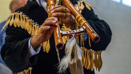 Fotobehang Close up of a Native American Indian playint at flute. © Daniel Avram