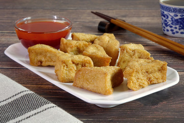 Tofu. Traditional fried Tofu , served with sweet chili sauce or sweet plum sauce. Famous Chinese appitizer / Chinese cuisine. Vegetarian food.