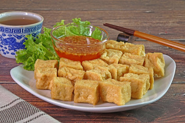 Tofu. Traditional fried Tofu , served with sweet chili sauce or sweet plum sauce. Famous Chinese appitizer / Chinese cuisine. Vegetarian food.