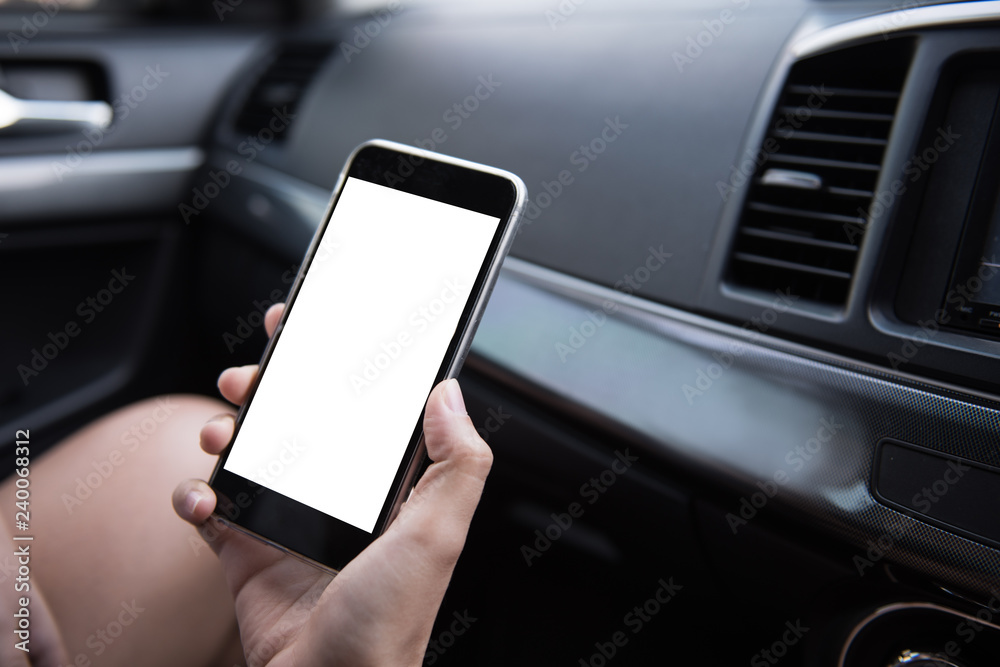 Aufkleber Hand using blank white screen mobile smartphone inside a car in sunny day, copy space for your app or product display,