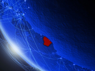 French Guiana on blue digital planet Earth from space with network. Concept of international communication, technology and travel.