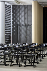 Dark wooden chairs on the background of the white columns
