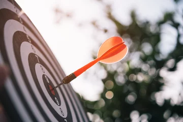 Tuinposter Bullseye is a target of business. Dart is an opportunity and Dartboard is the target and goal. So both of that represent a challenge in business marketing as concept. © Looker_Studio