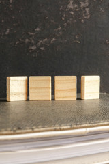 Blank wood scrabble pieces isolated on grunge black background.