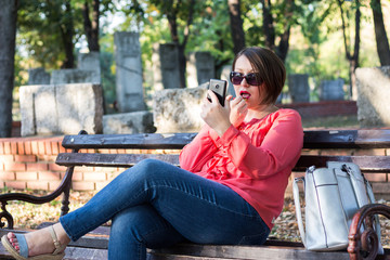 Girl Putting Lipstick on Her Lips and Using Cellphone Instead Mirror